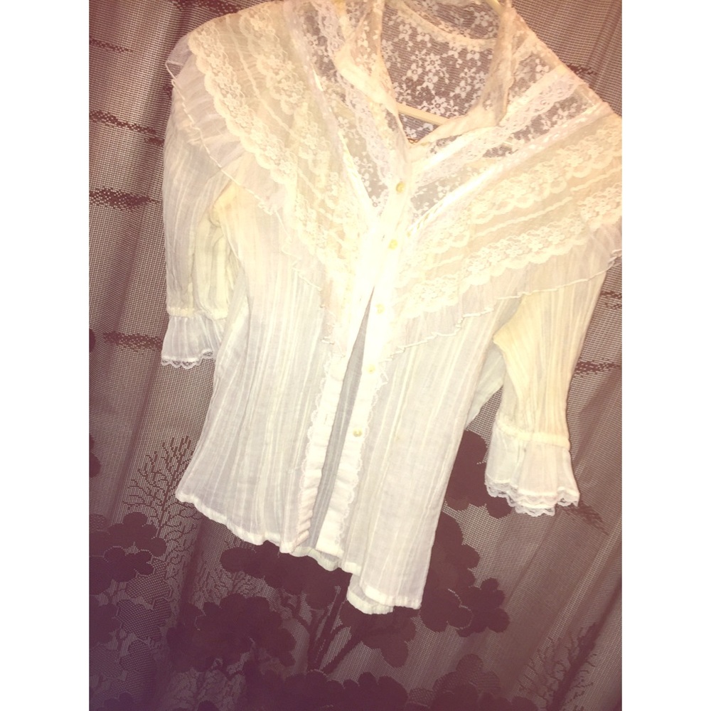 White/cream colored blouse.